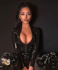 a woman in a latex outfit posing on a black background